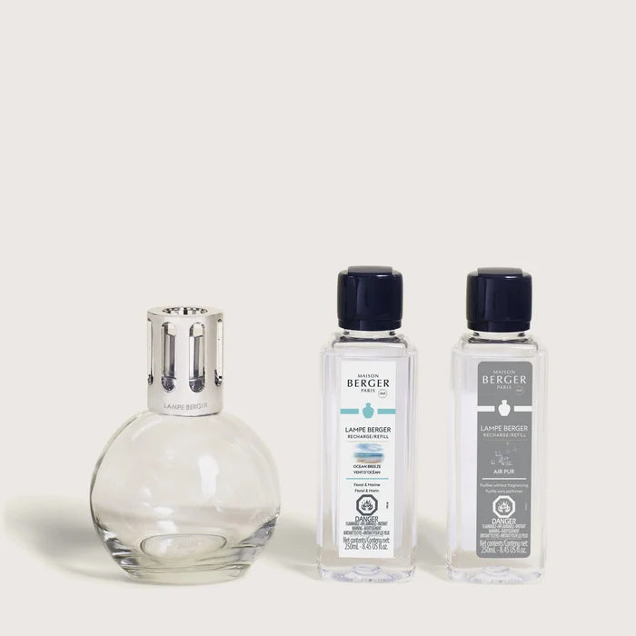 A Maison Berger fragrance lamp with a metal top alongside two 250ml refills labeled 'Ocean Breeze' and 'Air Pur So Neutral'.