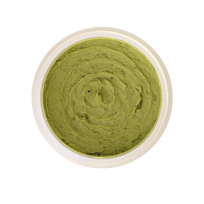 Green organic face mask with botanicals in a clear jar, natural skincare treatment