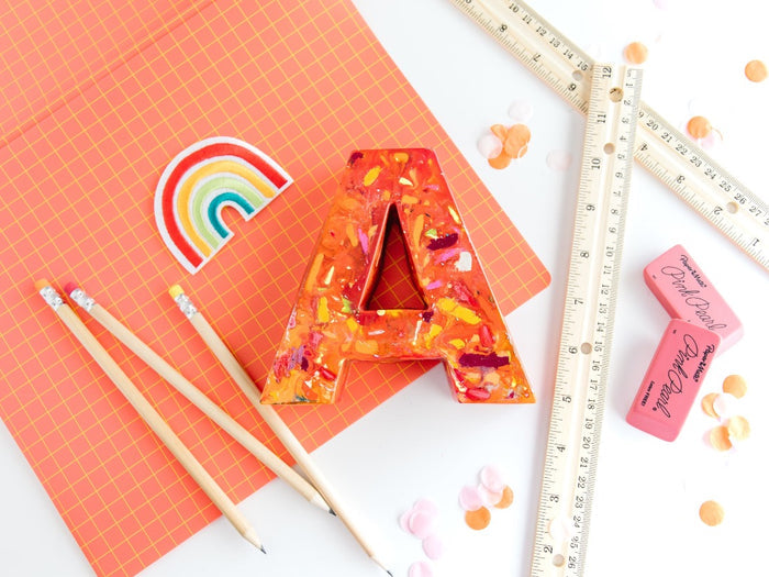 Large letter A crayon in orange and warm colors. This oversized crayon is a perfect teacher gift idea. Choose your own colors in rainbow crayon order. Average rating value of 5 out of 5.