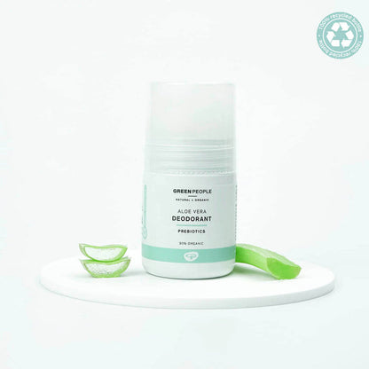 Green People aloe vera deodorant on a white background with slices of aloe vera.