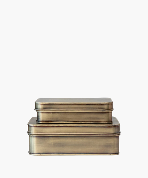 Two stacked vintage metal storage tins with a brushed brass finish. The tins are rectangular and convey a rustic, nostalgic feel against a white background. | SW Home
