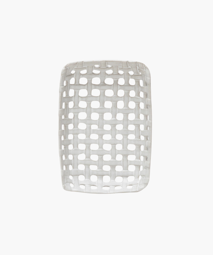 An overhead view of a white, rectangular ceramic basket dish with an open lattice design. The dish has a smooth finish and a contemporary look, evoking a minimalist style. | SW Home