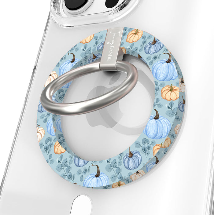 Blue Belle Pumpkin Patch Hold It Fancy MagSafe grip ring close-up on a clear iPhone case, showing the dusty blue ring with watercolor pumpkins and sage leaves around the silver rotating ring.