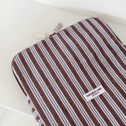 Brown, white and blue striped iPad Sleeve with silver zip and Coconut Lane logo badge.