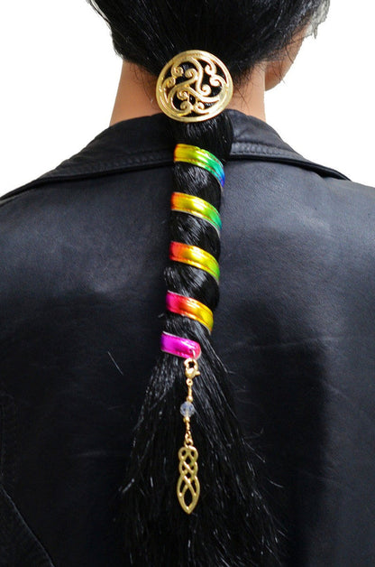 Model wearing Celtic rainbow hair wrap with gold spiral accent and dangling charm in a low ponytail, back view