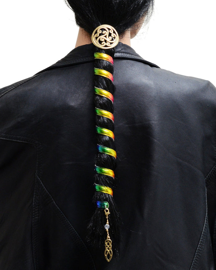 Model wearing 12 inch rainbow anodized aluminum ponytail wrap with gold Celtic charm and dangling accent, back view in ponytail