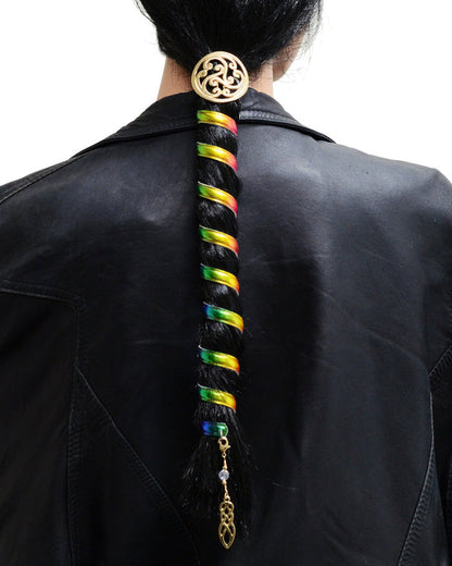 Model wearing 12 inch rainbow anodized aluminum ponytail wrap with gold Celtic charm and dangling accent, back view in ponytail