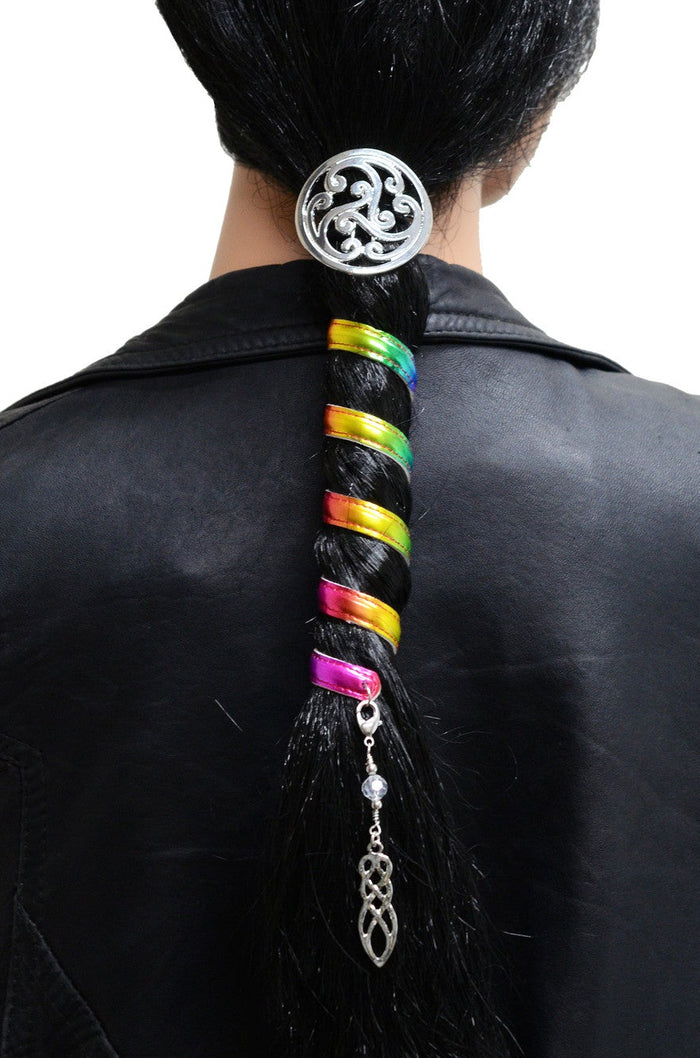Model wearing Celtic rainbow silver hair wrap with spiral design and dangling bead charm in a low ponytail, back view