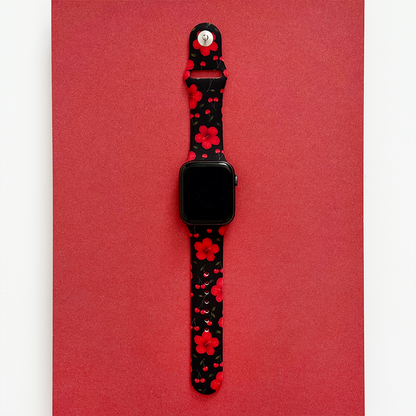 Cherry Hibiscus Apple Watch strap with red flowers on black, displayed on a bold red background.