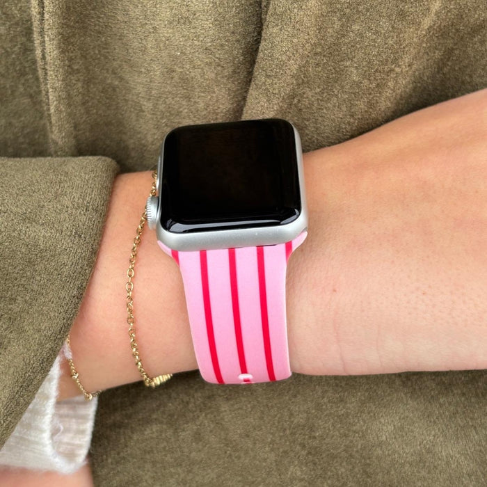 Coconut Lane Cherry Stripes Apple Watch strap with cherry and stripe pattern, worn with a gold chain bracelet.