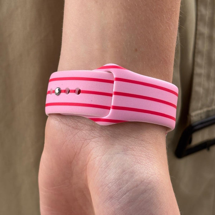Cherry Stripes Apple Watch strap by Coconut Lane on a wrist, featuring red and white stripes; khaki fabric background.