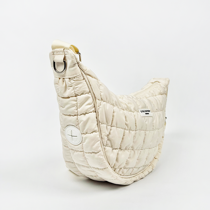 Coconut Lane crossbody crescent dog walking bag in light grey with a curved design and white side patch.