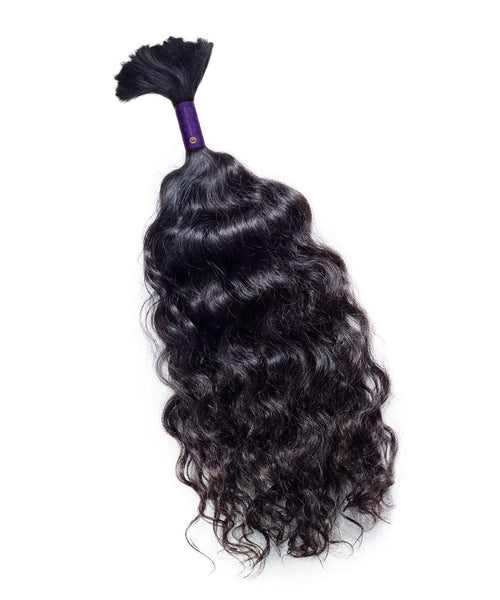 A bundle of Perfect Locks Curly Bulk Hair for Braiding in Natural Black  is secured at the top against a white background.