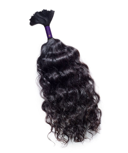 A bundle of Perfect Locks Curly Bulk Hair for Braiding in Natural Black  is secured at the top against a white background.