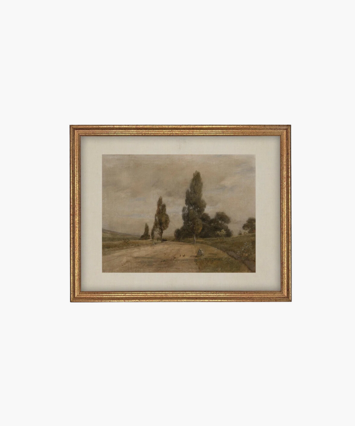 Framed landscape painting depicting a serene countryside with a dirt path, tall trees, and a cloudy sky with a marx gold frame. The muted tones evoke a calm, peaceful mood.  | Wildwood Home Co.