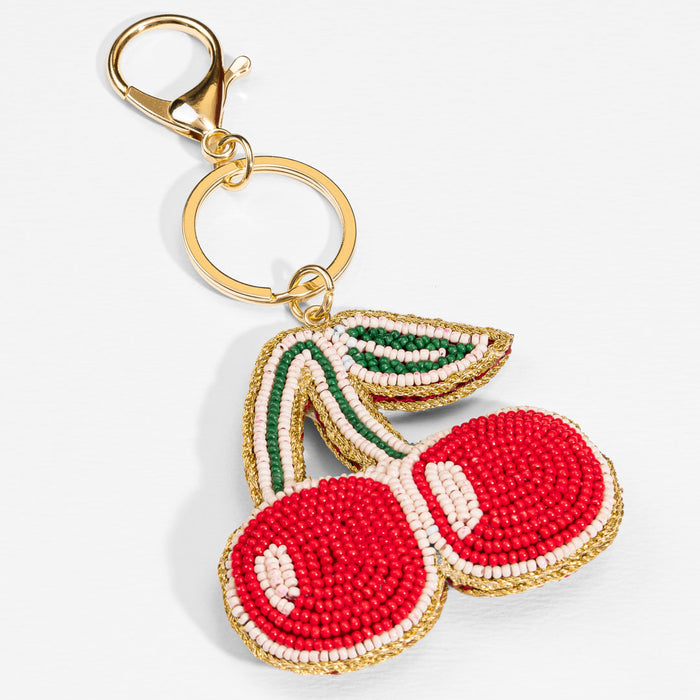 Glossy cherry-inspired bag charm with beads and metal loop, made to brighten your favourite tote