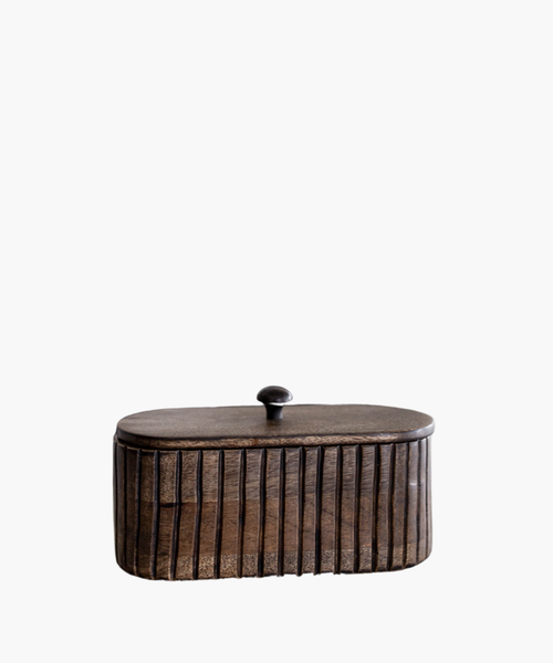 A dark wooden oval box with vertical grooves and a small round handle on top. The wood's texture feels rustic, conveying a warm, vintage aesthetic. | SW Home