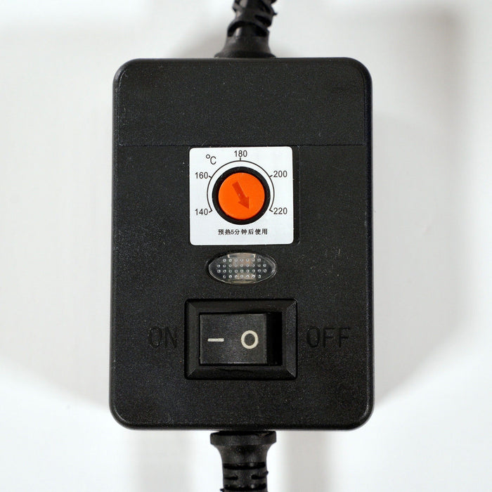 A black control box with an orange Celsius temperature dial, small indicator light, and black on/off switch. Two insulated cables extend from the top and bottom.