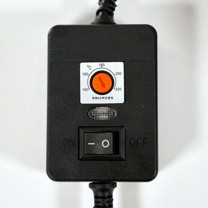 A black control box with an orange Celsius temperature dial, small indicator light, and black on/off switch. Two insulated cables extend from the top and bottom.