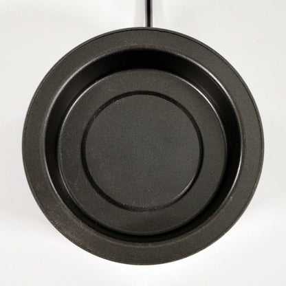 Top view of a round, black, nonstick frying pan with a smooth surface and outward handle on a plain white background.