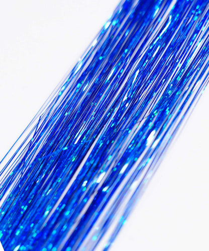 Close-up of Perfect Locks Perfect Hair Tinsel in Rust with long, shiny strands on a white background, sparkling in the light.#color_royal-blue