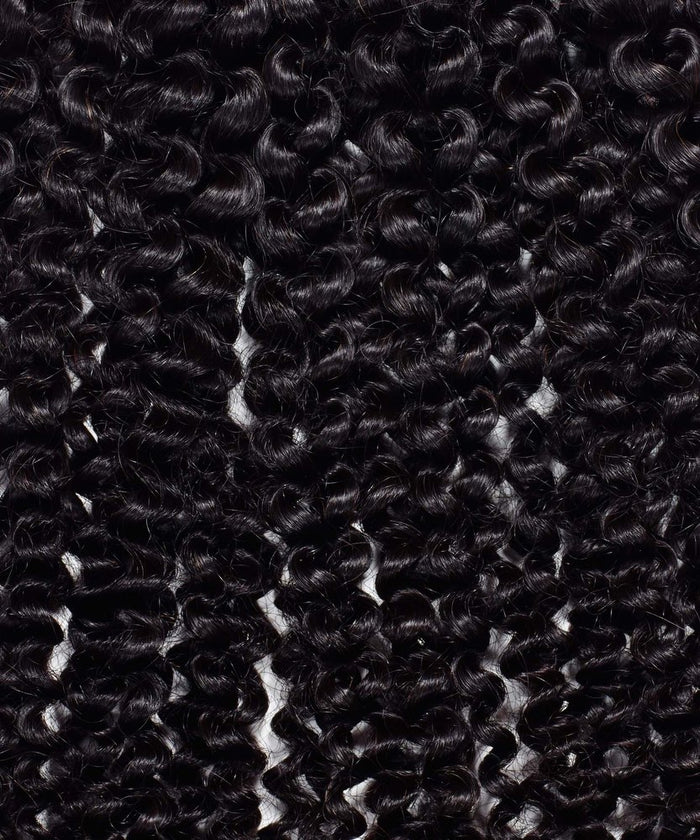 Close-up of tightly coiled, shiny black Kinky Curly Steam Permed Machine Weft hair extensions, neatly arranged in uniform rows.