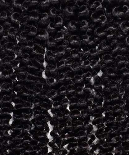 Close-up of tightly coiled, shiny black Kinky Curly Steam Permed Machine Weft hair extensions, neatly arranged in uniform rows.