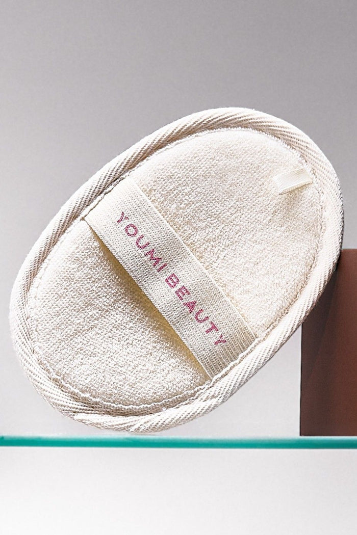 White Loofah with 'Youmi Beauty' label on a gray background