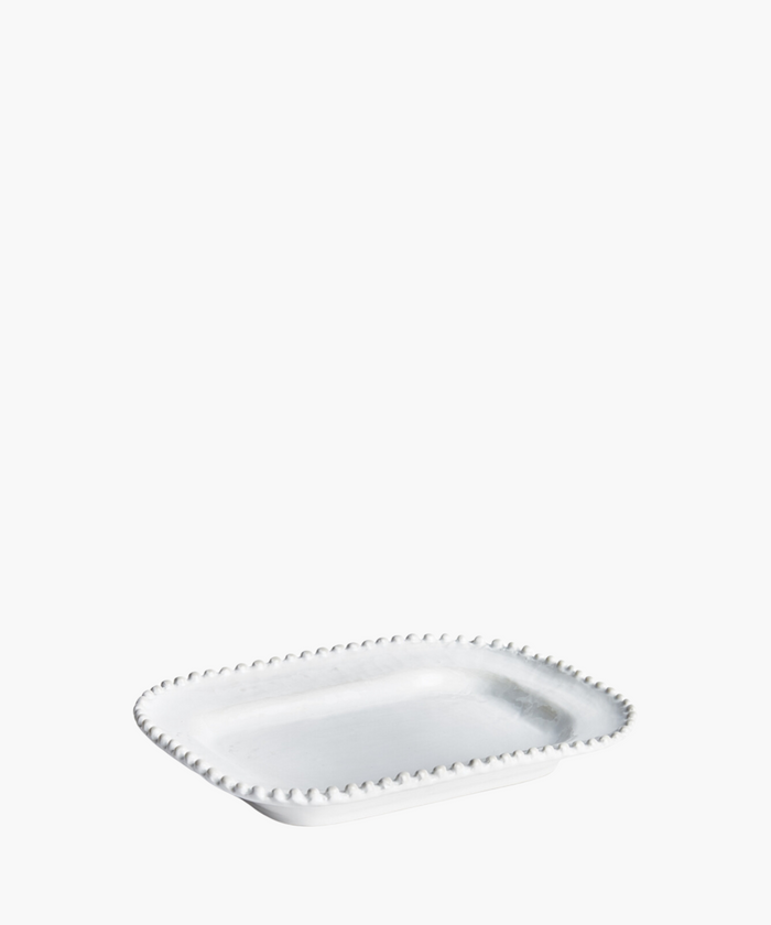 A rectangular, white ceramic plate with a beaded edge design is displayed on a plain white background, conveying a sense of elegance and simplicity. | SW Home