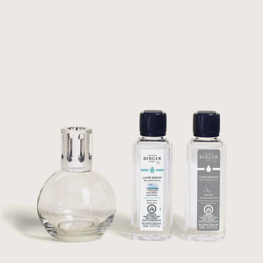 A Maison Berger fragrance lamp with a metal top alongside two 250ml refills labeled 'Ocean Breeze' and 'Air Pur So Neutral'.