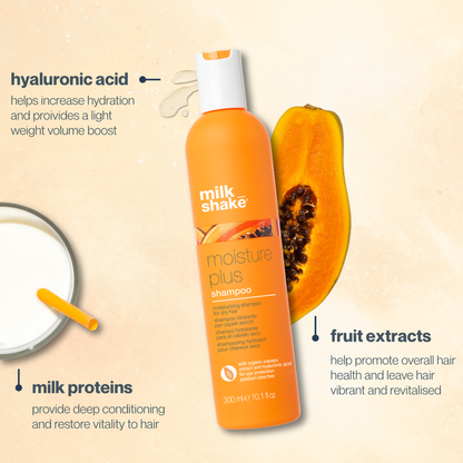Orange milk_shake moisture plus shampo bottle with a papaya on a beige background