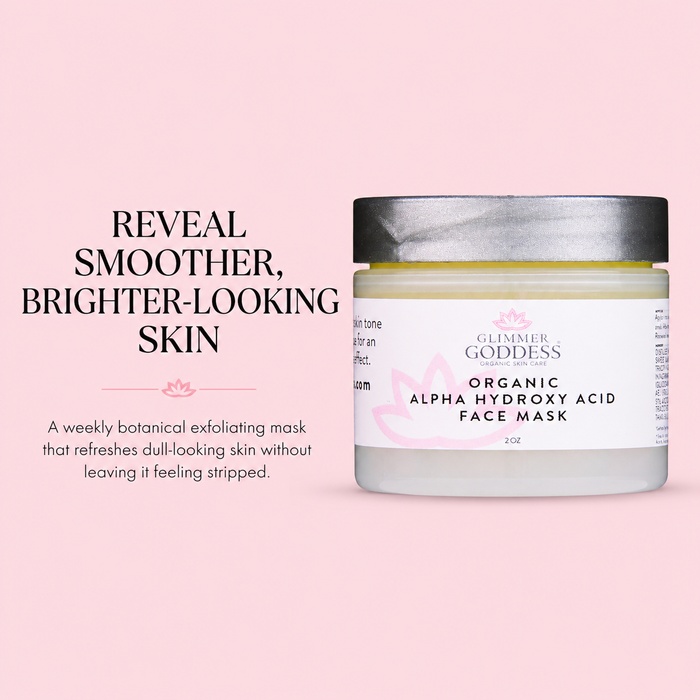 Glimmer Goddess Organic Alpha Hydroxy Acid Face Mask in a frosted glass jar with a silver lid, set against a solid pink background with promotional text.