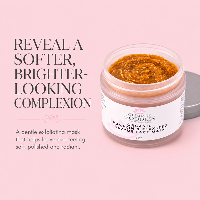 A jar of Glimmer of Goddess Pumpkin & Flaxseed Enzyme Face Mask shown on a soft pink background with promotional text. The clear jar reveals a textured orange-brown mask inside, with a white label and a gray lid resting beside it.
