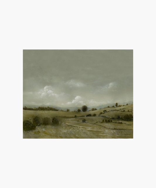 A serene landscape painting depicts rolling hills under a cloudy gray sky. The muted green and brown tones evoke a calm, tranquil atmosphere. | Wildwood Home Co.