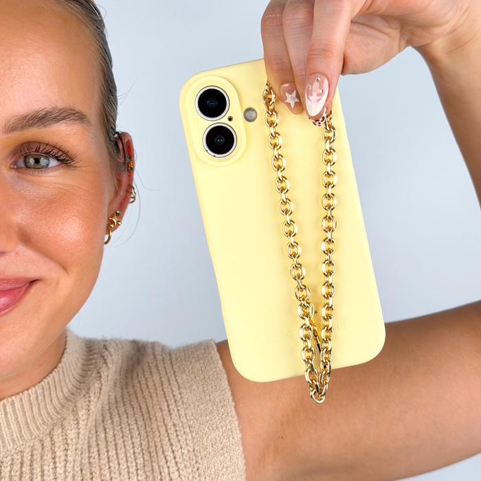 Gold chain phone strap attached to butter soft yellow phone case