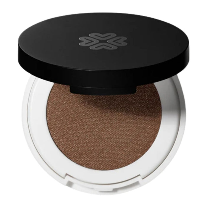 Compact brown pressed eye shadow in a white case with a black lid on a white background