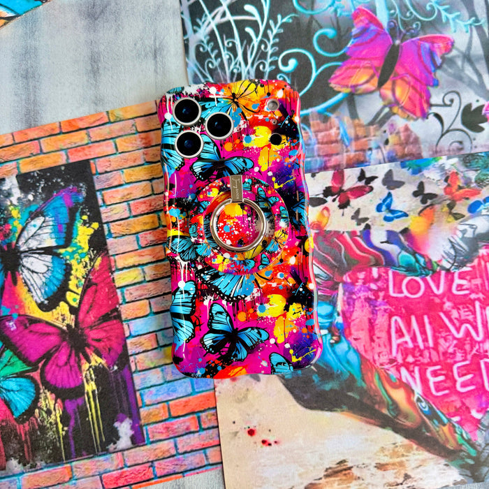 Rebel Wings graffiti butterfly MagSafe phone grip ring with electric blue butterflies, pink and orange paint splatters, and grunge street art design compatible with iPhone and Samsung