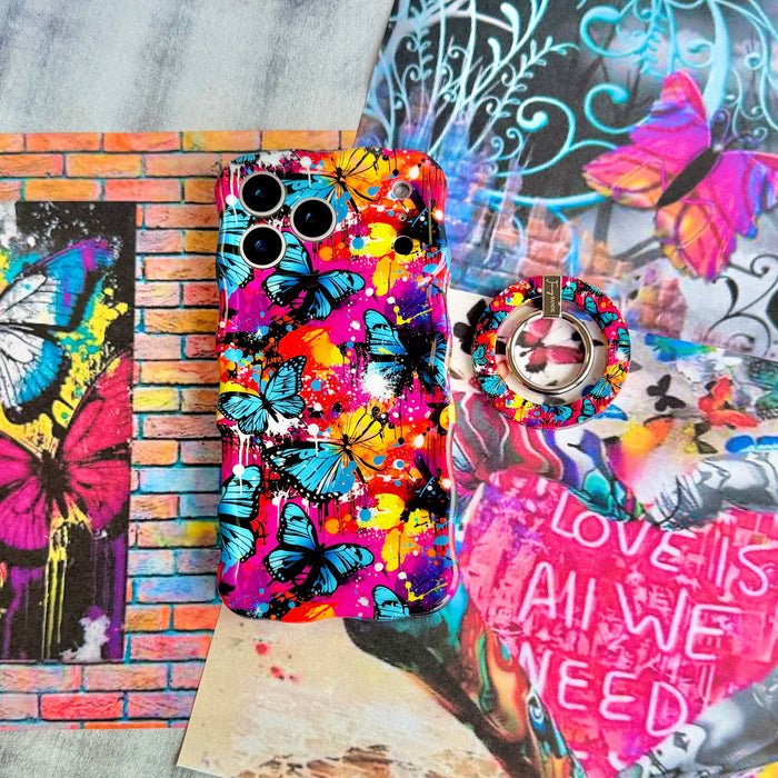 Rebel Wings graffiti butterfly MagSafe phone grip ring with electric blue butterflies, pink and orange paint splatters, and grunge street art design compatible with iPhone and Samsung