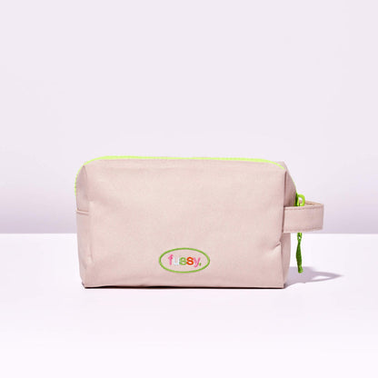 Fussy's Recycled Washbag in pale pink with a lime green zip and Fussy logo