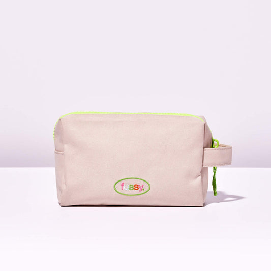 Fussy's Recycled Washbag in pale pink with a lime green zip and Fussy logo