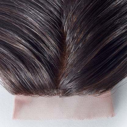 Close-up of dark brown hair on a light pink, sheer lace base for lace front wigs, highlighting the natural-looking hairline and parting.