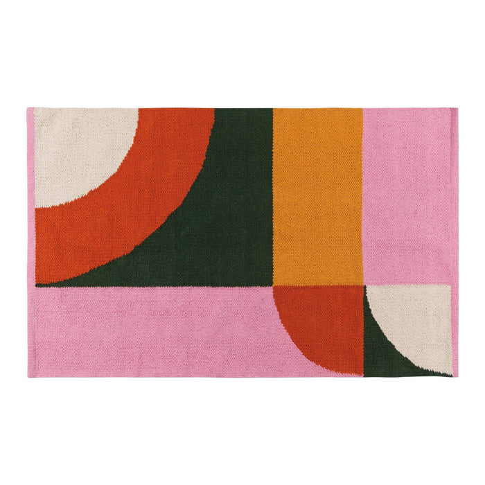Geometric patterned rug with colorful shapes on a pink background