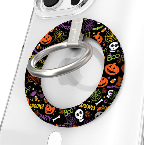 Spooky Hold It Fancy MagSafe grip ring shown on a clear iPhone case, black ring covered in orange pumpkins, white skulls and spiderwebs.