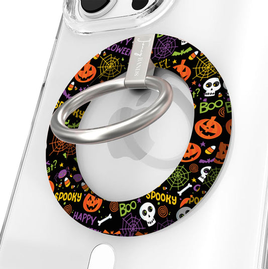 Spooky Hold It Fancy MagSafe grip ring shown on a clear iPhone case, black ring covered in orange pumpkins, white skulls and spiderwebs.