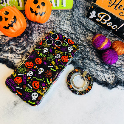 Spooky MagSafe grip ring lying beside the matching Wavy Luxe case, showing the black pumpkin and skull print on both.