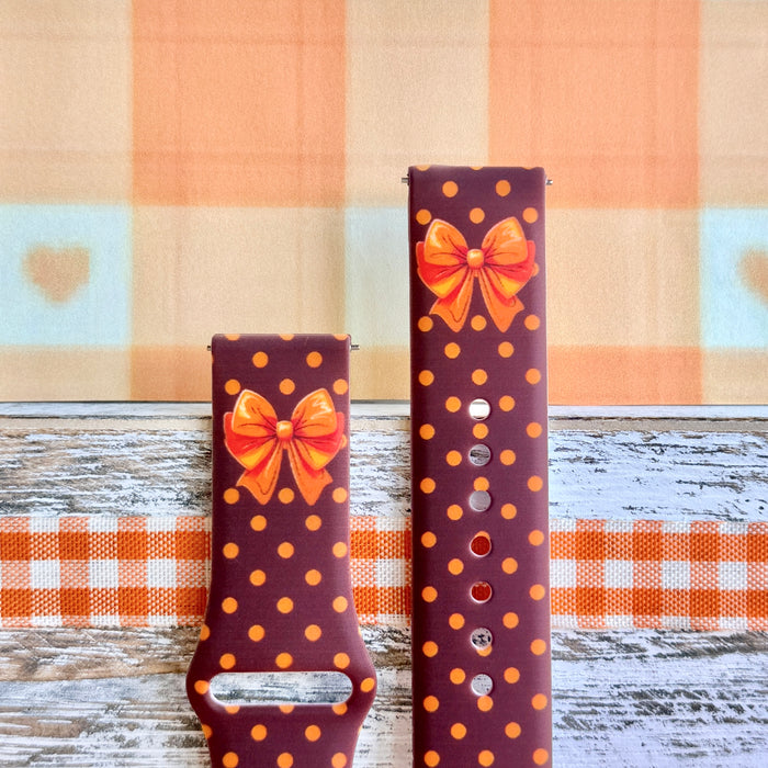 Spotted Looking Cute Samsung Galaxy Watch band front view of both strap halves, showing the orange bow near the top of each half and the quick-release pin holes.