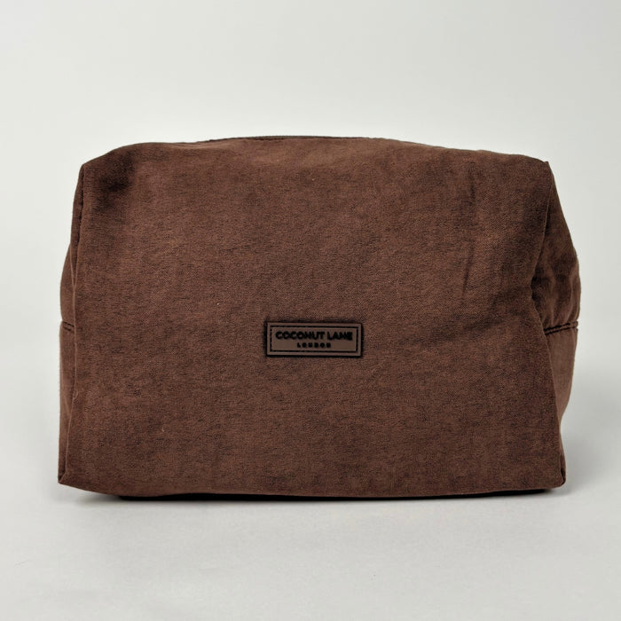 Chocolate brown suedette makeup bag with a black label, minimalist design by Coconut Lane.