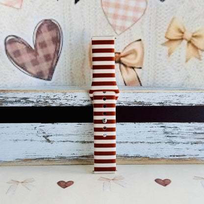 Sweet Espresso Stripes Samsung Galaxy Watch band single strap half standing on weathered wood, showing the espresso and cream stripe print end to end.