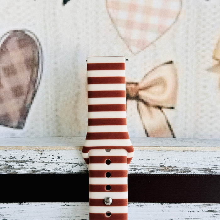 Close-up of the Sweet Espresso Stripes Samsung Galaxy Watch band showing the smooth silicone finish and the even spacing of the brown and cream stripes.