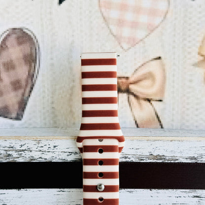 Close-up of the Sweet Espresso Stripes Samsung Galaxy Watch band showing the smooth silicone finish and the even spacing of the brown and cream stripes.